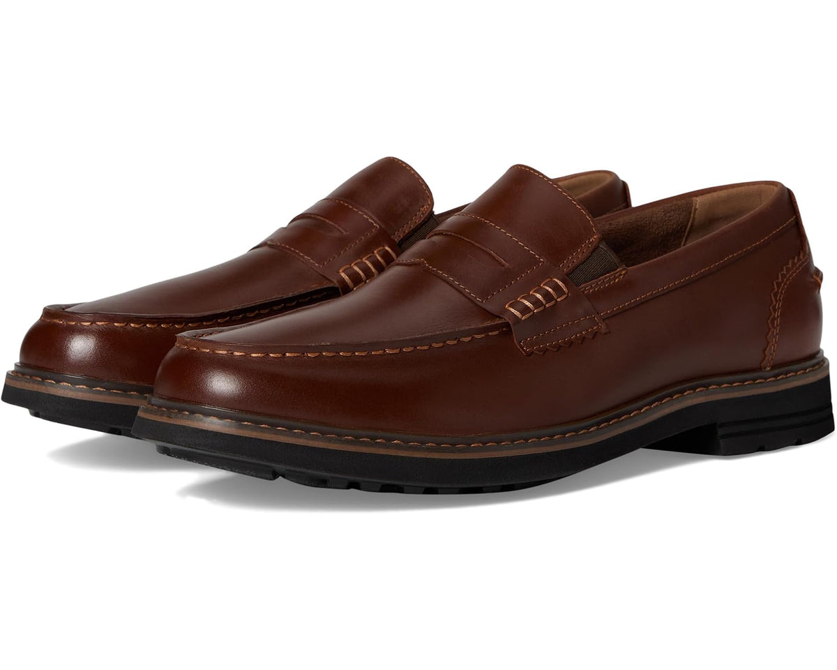 Cognac moc-toe penny loafer with slip-on strap and stitched detailing, rubber sole