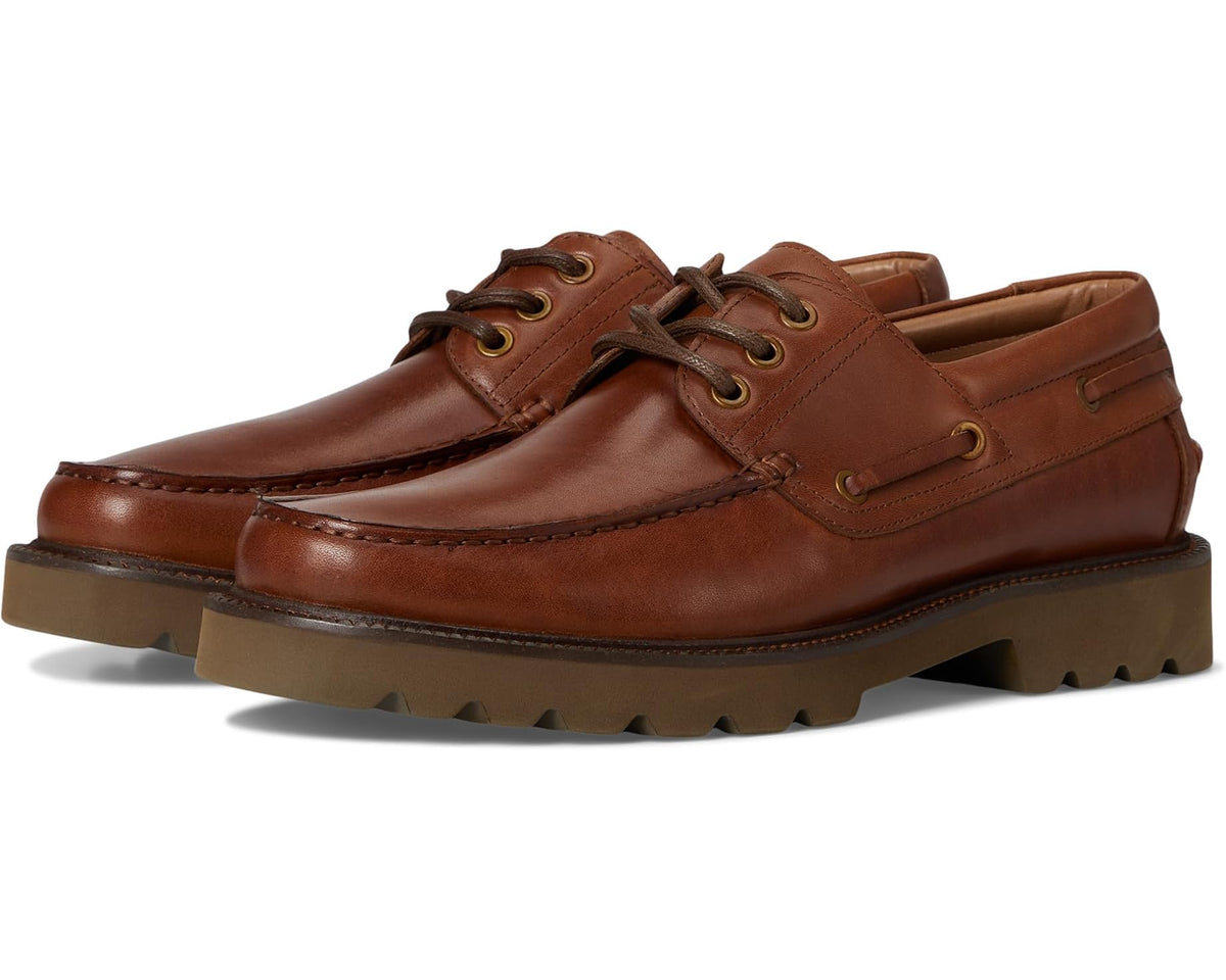 Men's tan leather boat shoe with laces, side eyelets, and chunky rubber sole