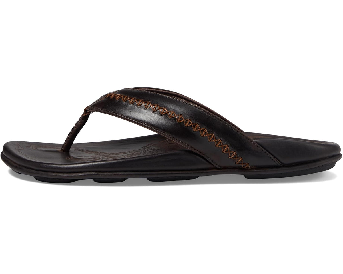 OluKai men's dark brown flip-flop sandals with tan stitched thong strap, side view