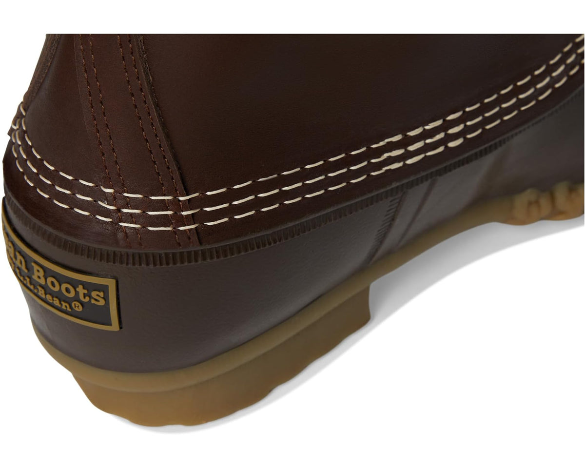 Brown boot heel and side seam with white stitching and tan rubber outsole edge.