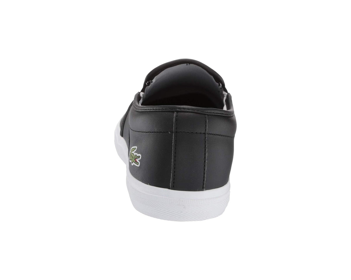 Black slip-on sneaker back view with green Lacoste logo and white sole