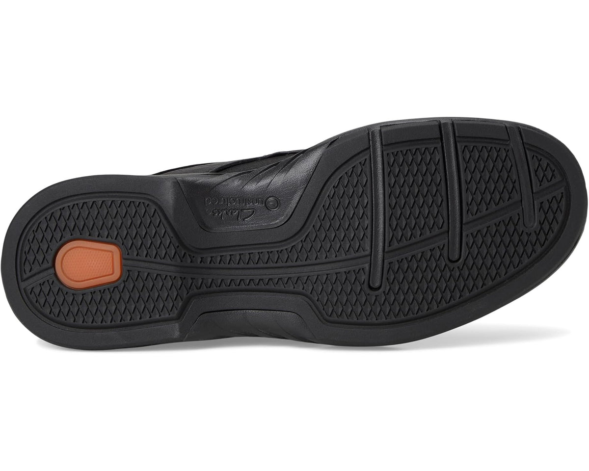 Black rubber outsole with textured tread pattern and heel support panel.