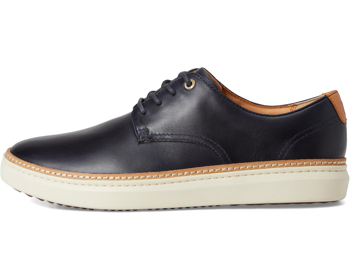 Men's dark navy plain-toe oxford with lace-up front, moc stitching, and cream sole