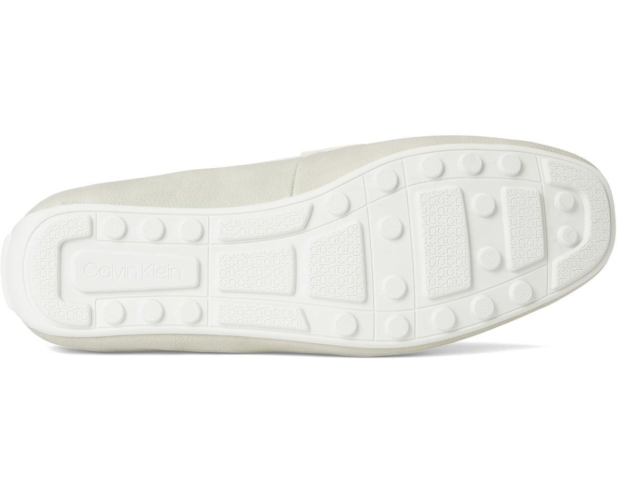 Light-colored outsole with textured tread pods and Calvin Klein logo