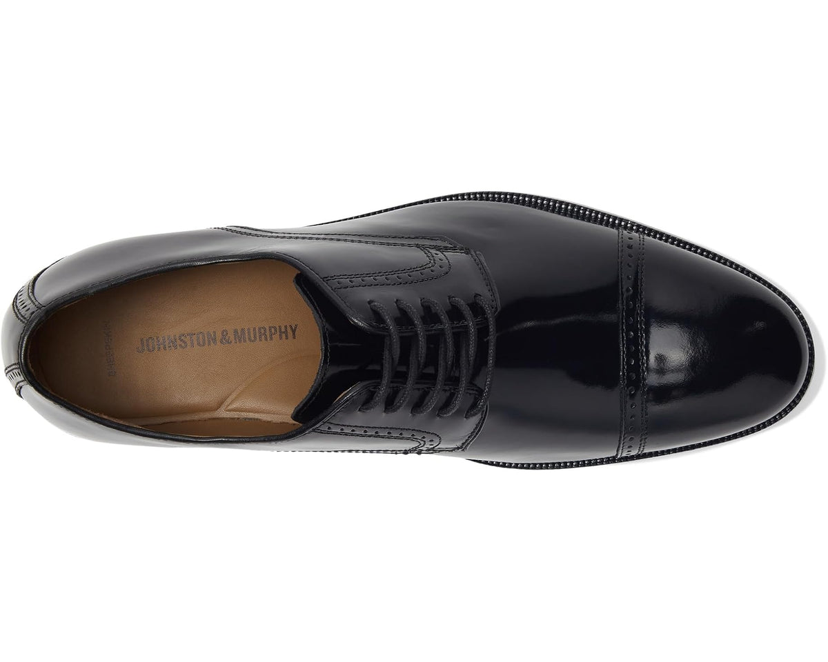 Black cap-toe Oxford shoe with lace-up vamp and tan-lined interior opening