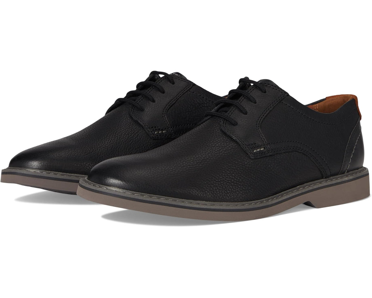 Black leather low-top lace-up men's shoe with dark sole and side panels
