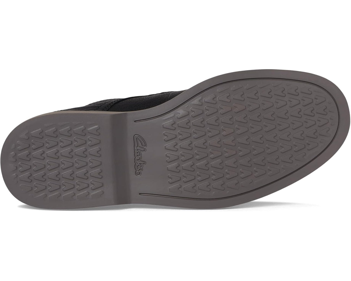Black leather low-top shoe outsole with textured rubber tread