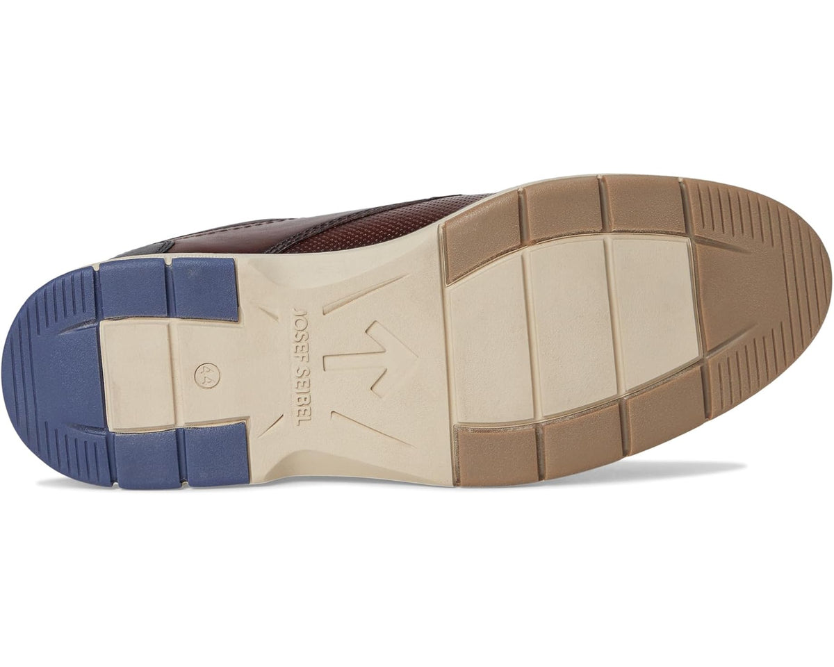 Shoe outsole with color-block tread, shown from underside view