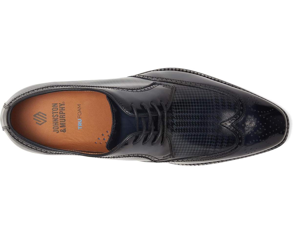 Black lace-up wingtip oxford shoes with houndstooth pattern, view of interior lining.