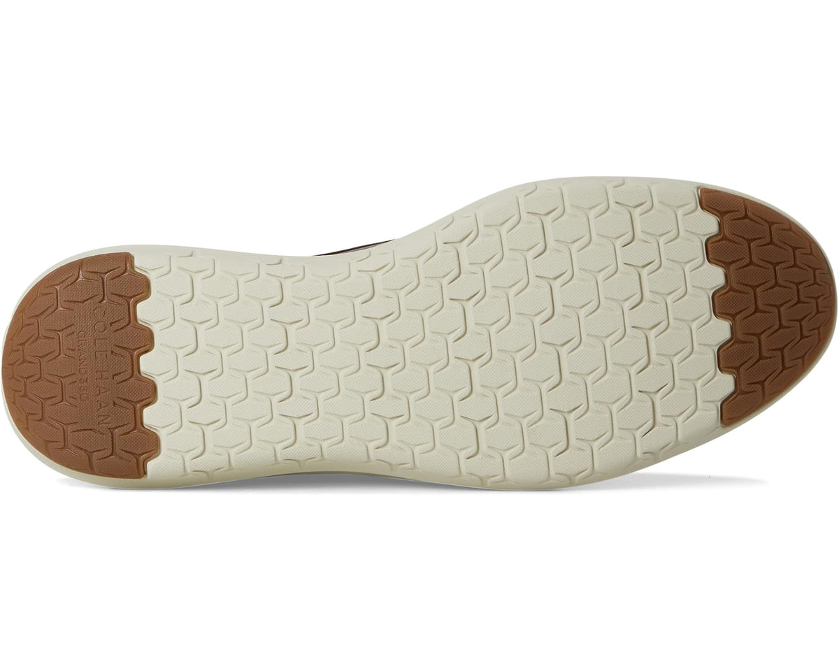 Sole of men's dark brown oxford shoes with textured grip outsole and tan heel