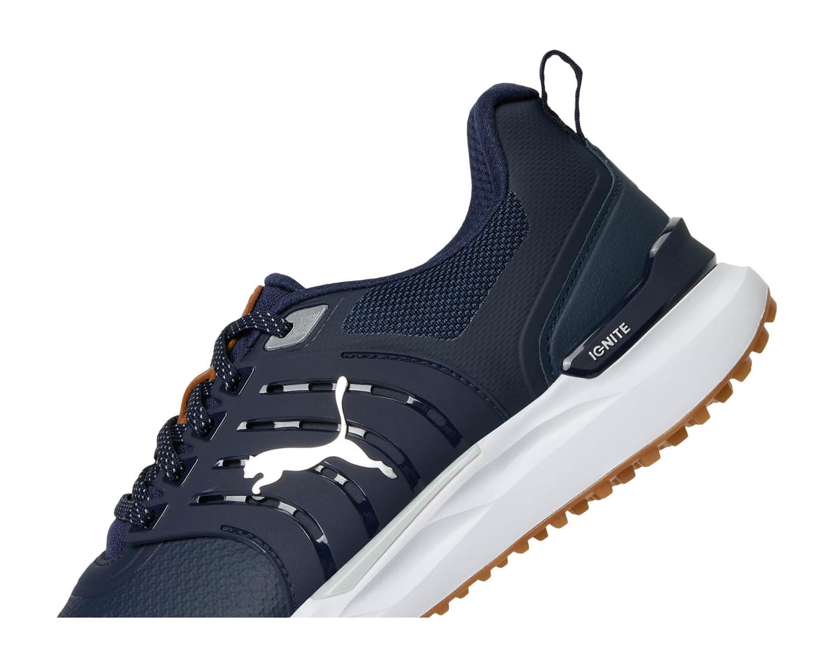 Men's PUMA golf shoe side view in deep navy with IGNITE badge and brown tread