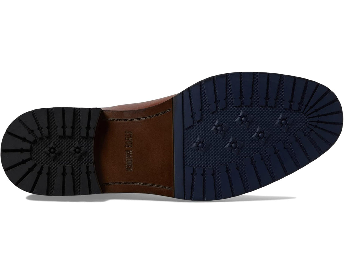 Boot sole view: tan leather Chelsea boot with rugged tread outsole