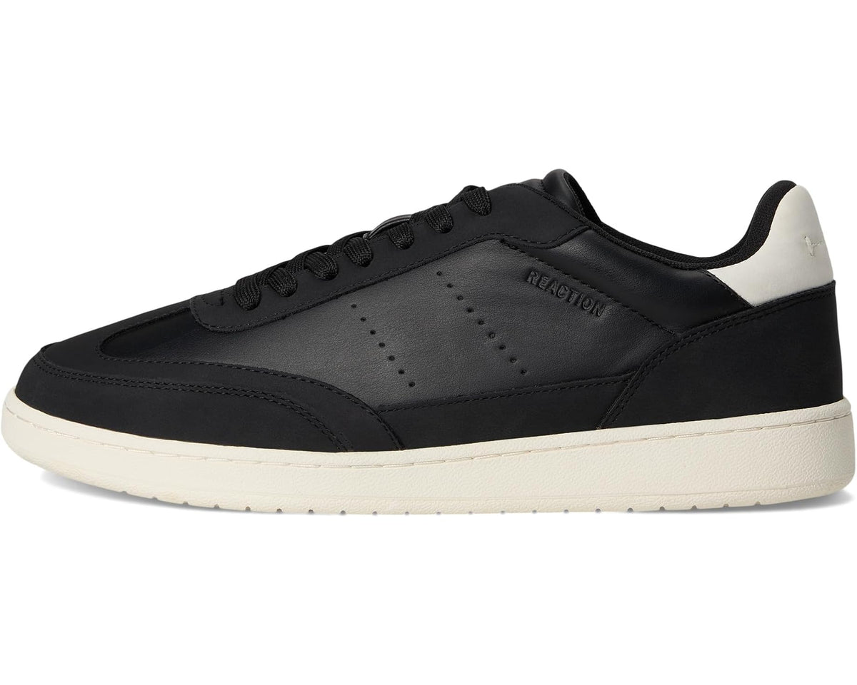 Black low-top sneaker with white panel accents, lace-up front and side logo
