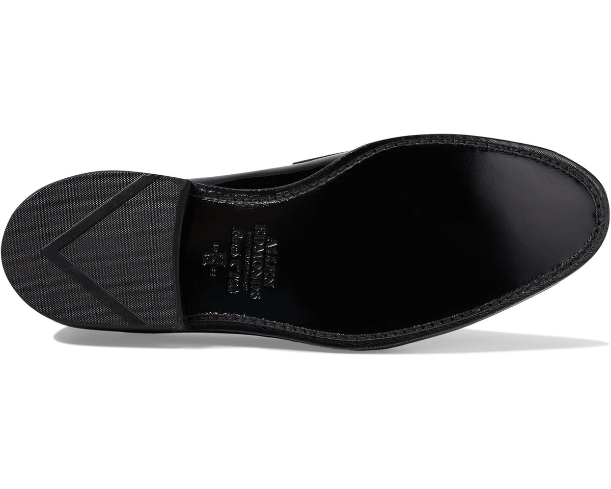 Black patent leather loafer with textured outsole and cushioned insole