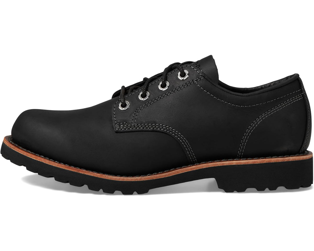 Black leather lace-up plain-toe shoe with stitched panels and rubber lug sole