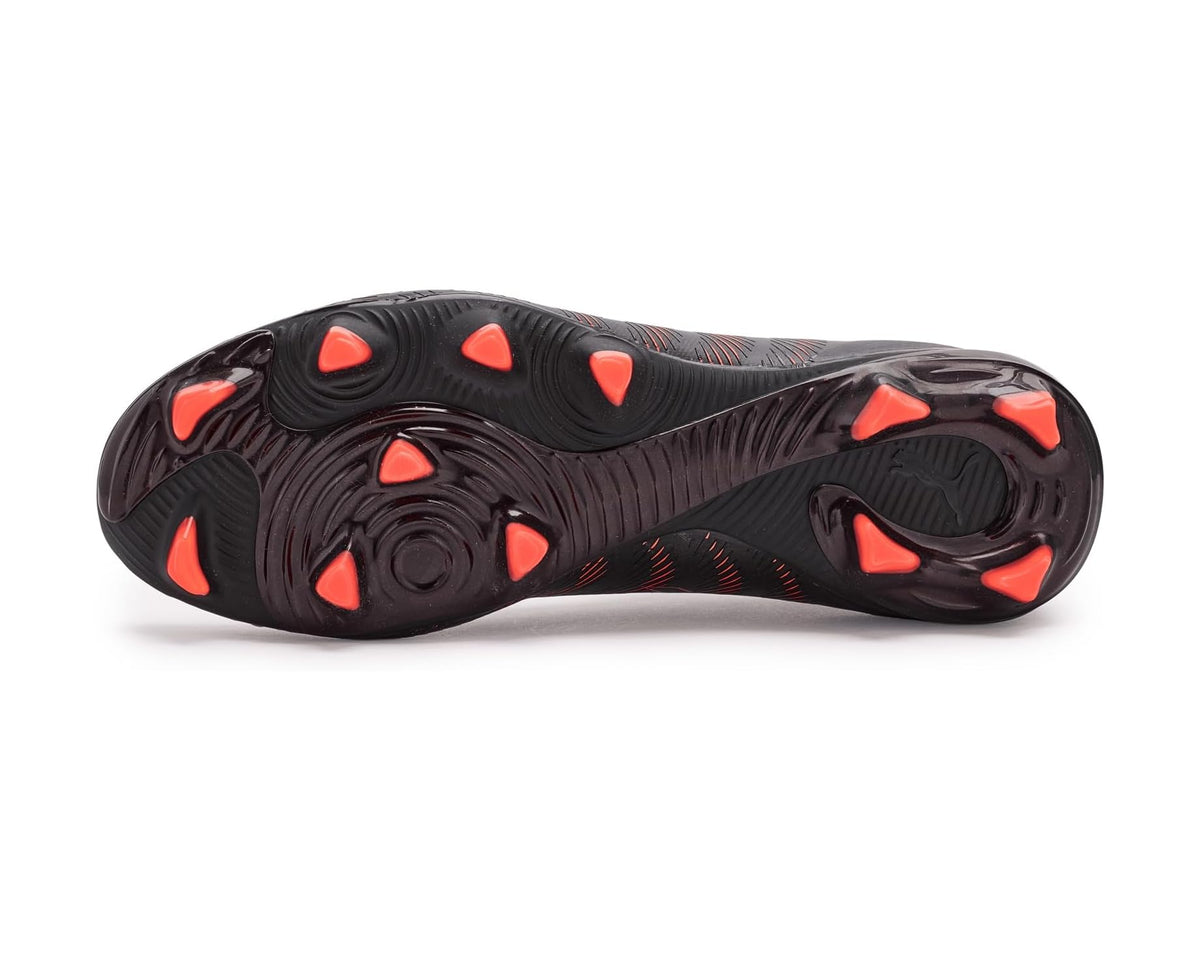 Black firm-ground cleat outsole with red/orange studs and molded traction pattern.