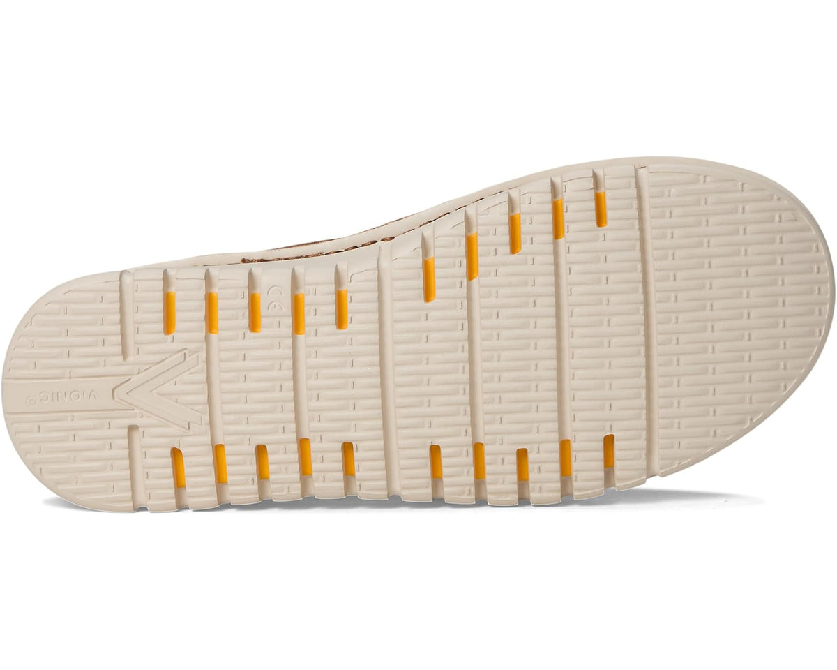 White rubber outsole of hazelnut brown slip-on mules with traction ridges
