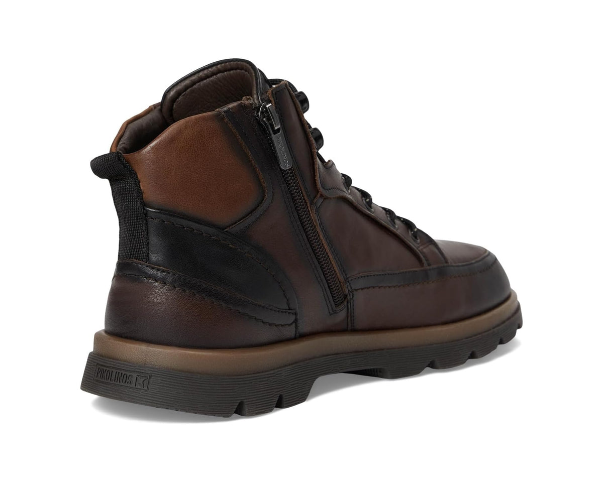Men's brown ankle boots with side zipper, black heel panel, and rugged tread sole