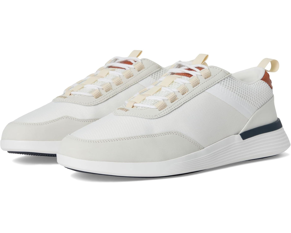 White low-top lace-up crossover sneakers with tonal panels and navy heel stripe