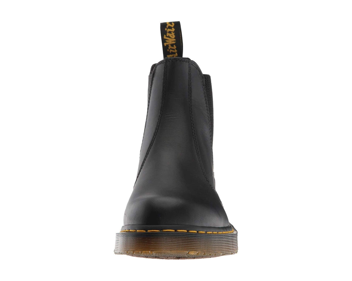 Dr. Martens black leather chelsea boots angled back view with pull loop and tread sole