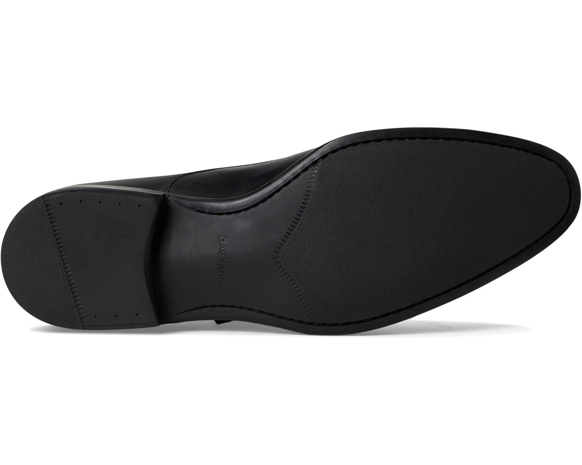 Black leather men's dress shoe outsole view, buckle strap side.
