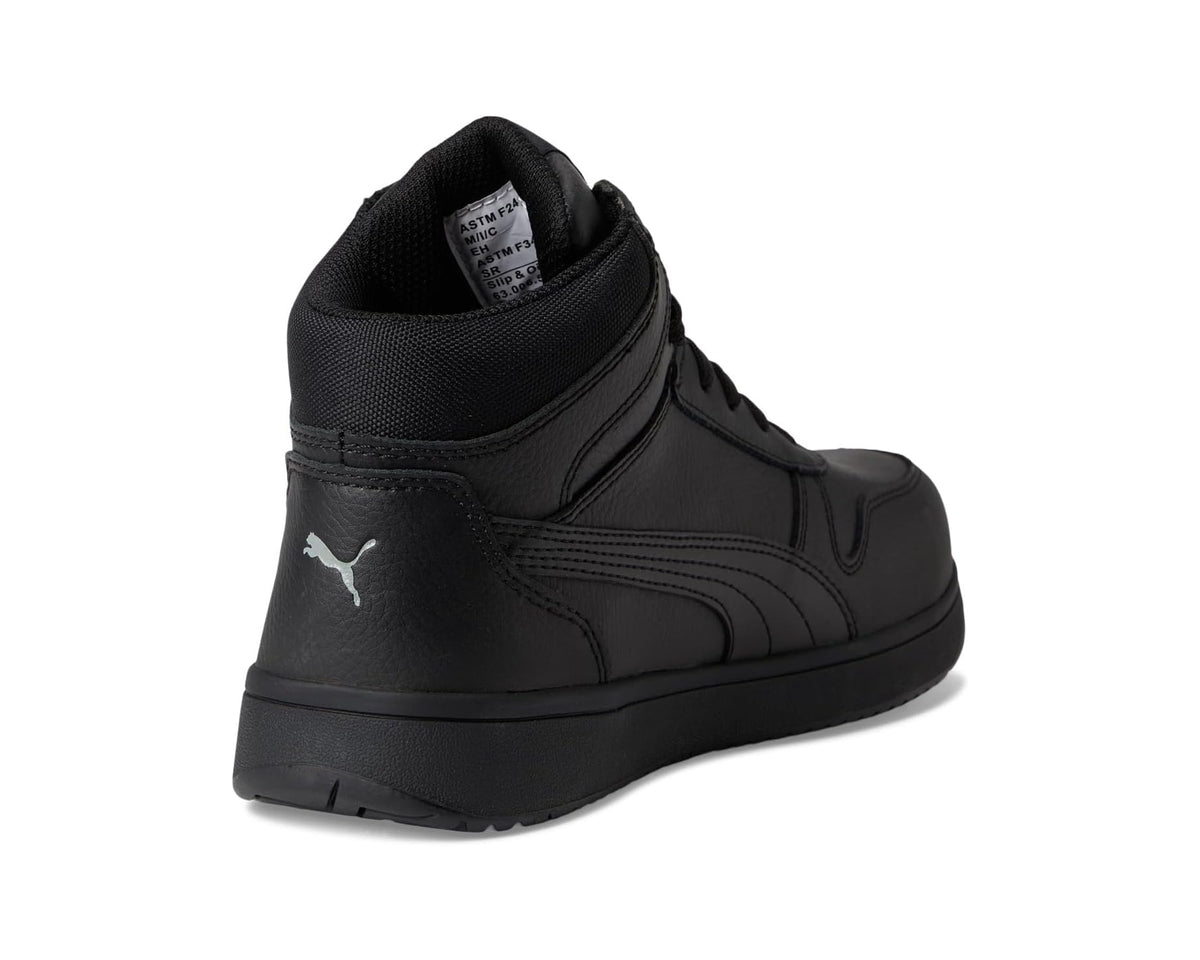 Black PUMA safety mid sneaker, heel view with rear logo and cushioned collar.