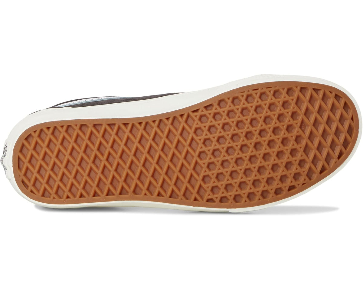 Vans dark suede low-top sneaker outsole with white sidewall and tan gum tread