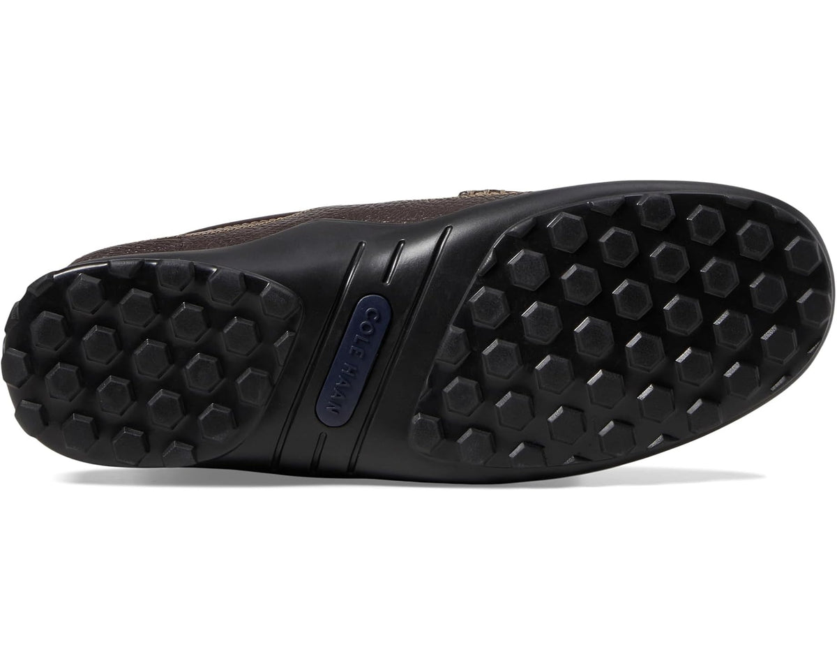 Dark brown leather loafer outsole with textured rubber tread and blue heel logo