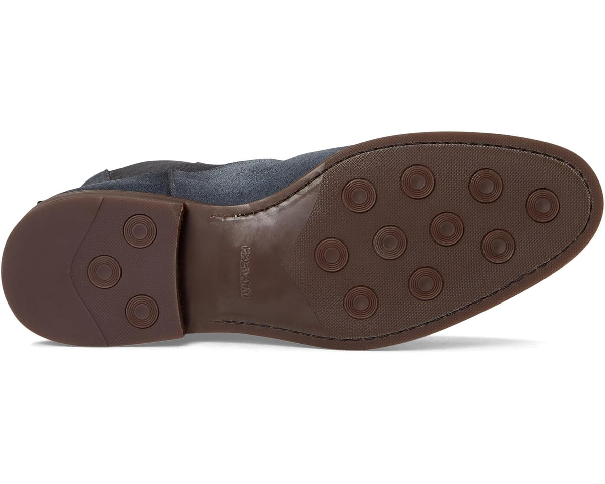 Underside of indigo suede Chelsea boot showing rubber tread outsole.