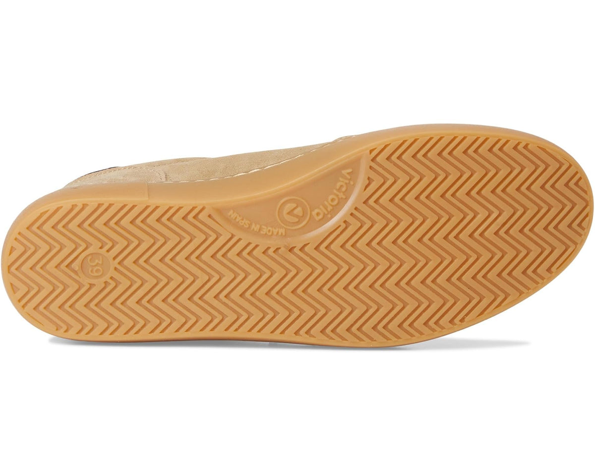 Beige rubber outsole with zigzag traction pattern and brand markings