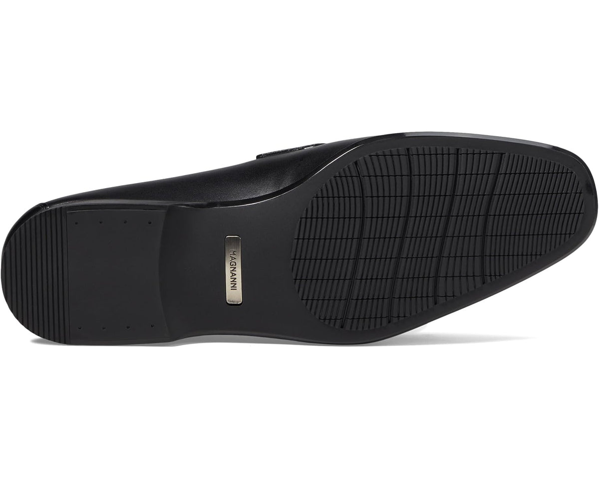 Black rubber sole with textured tread and small brand label