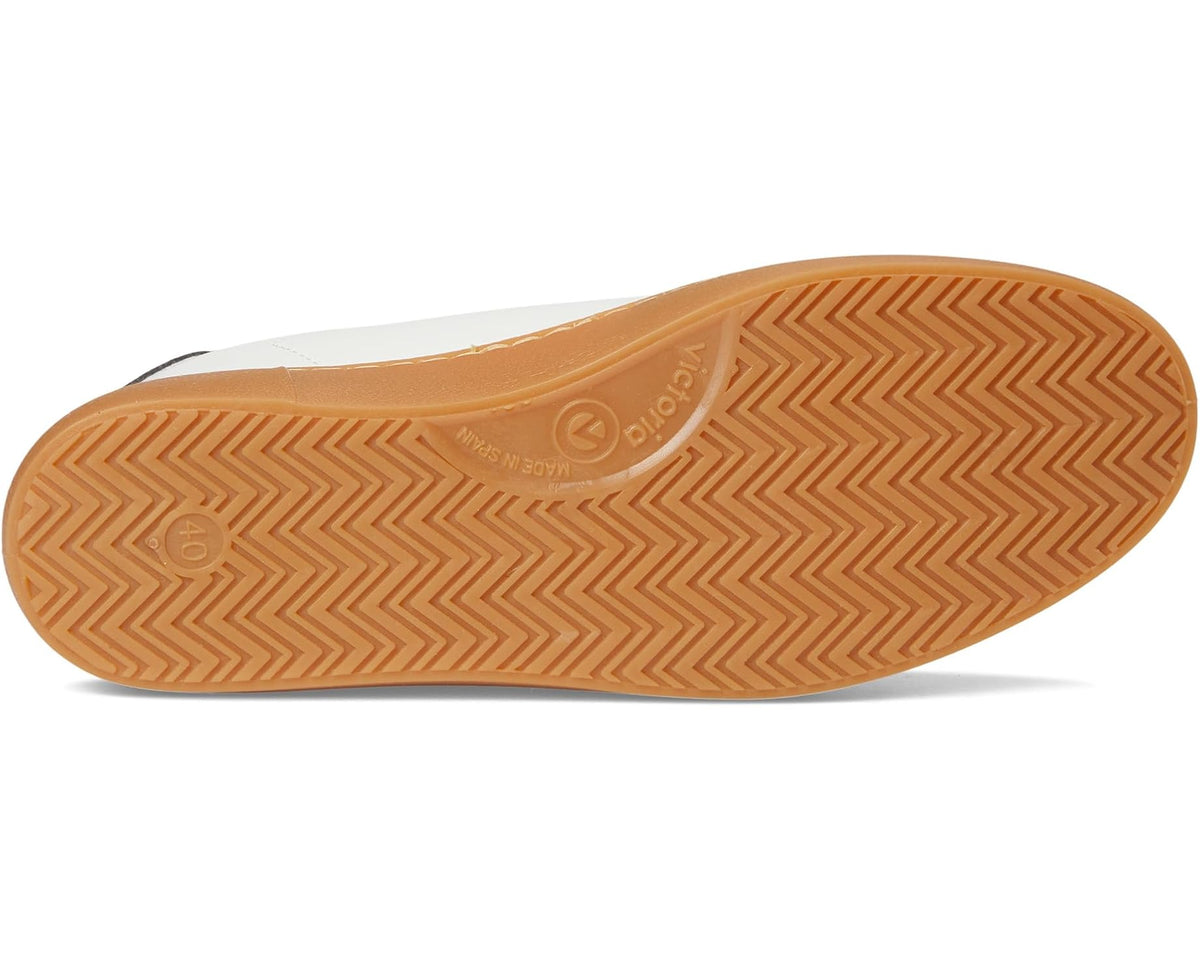 Low-top sneaker outsole with tan gum tread and zigzag pattern