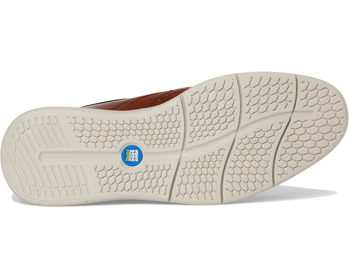 Men's cognac oxford shoe outsole with textured tread and beige rubber sole