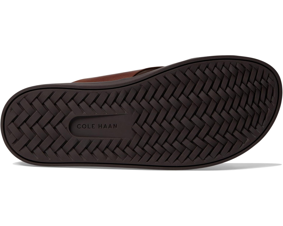 Men's dark brown slide sandals with braided outsole and COLE HAAN logo on sole