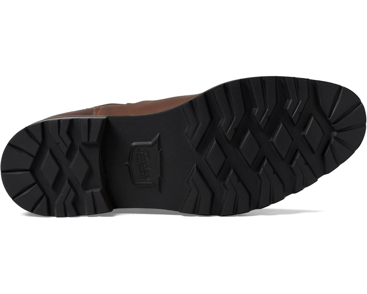 Men's brown boot outsole with textured tread and centered logo detail