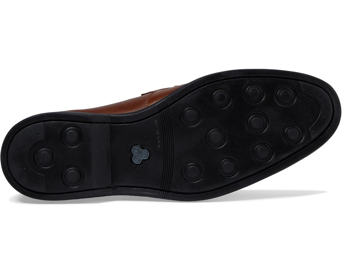 Men's brown leather loafer outsole with textured rubber tread
