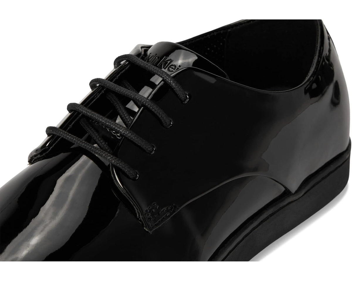 Black patent leather lace-up dress shoe with textured tongue and eyelets