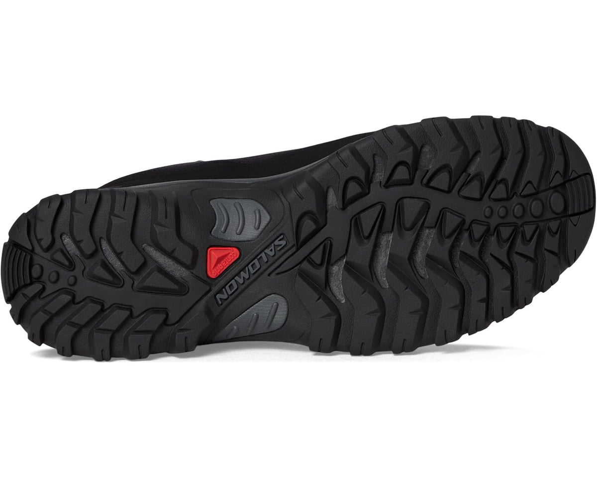 Black Salomon men's hiking boot outsole with deep tread and red accent