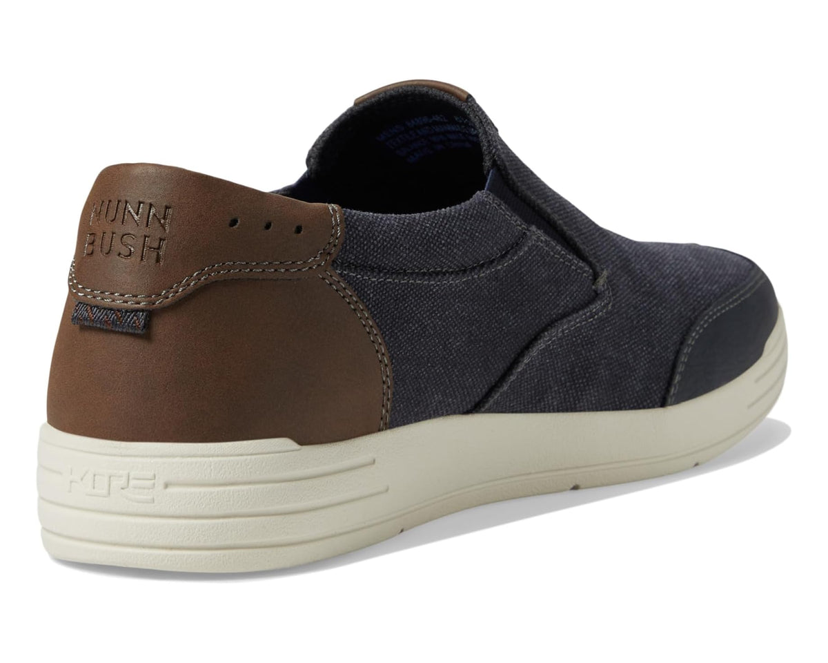 Dark blue canvas slip-on shoe with brown heel lining and stitched back seam