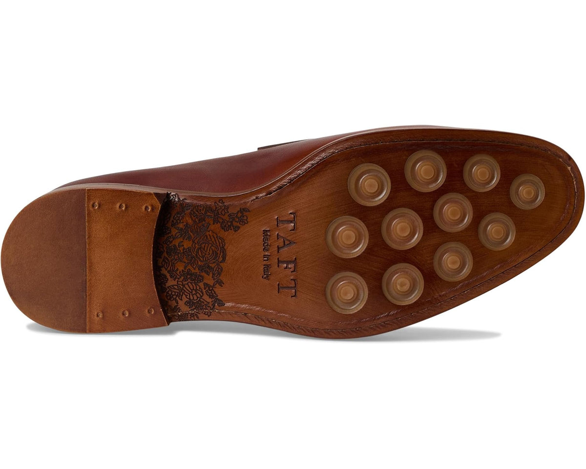 Men's brown leather loafer outsole with round tread studs and brand marking