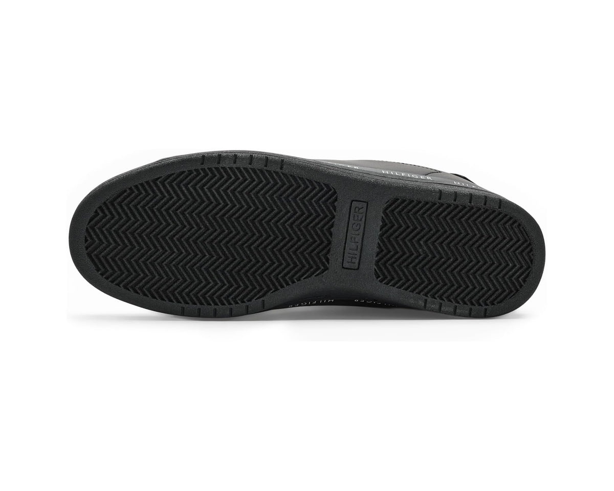 Black sneaker outsole with textured herringbone tread pattern