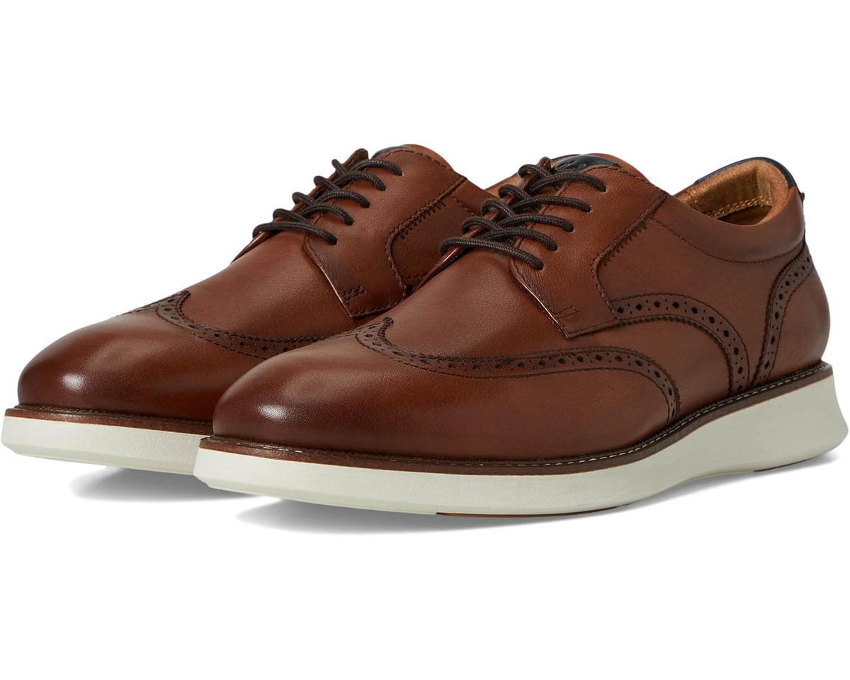 Men’s wingtip Oxford dress shoes, cognac brown, lace-up, cushioned white sole.