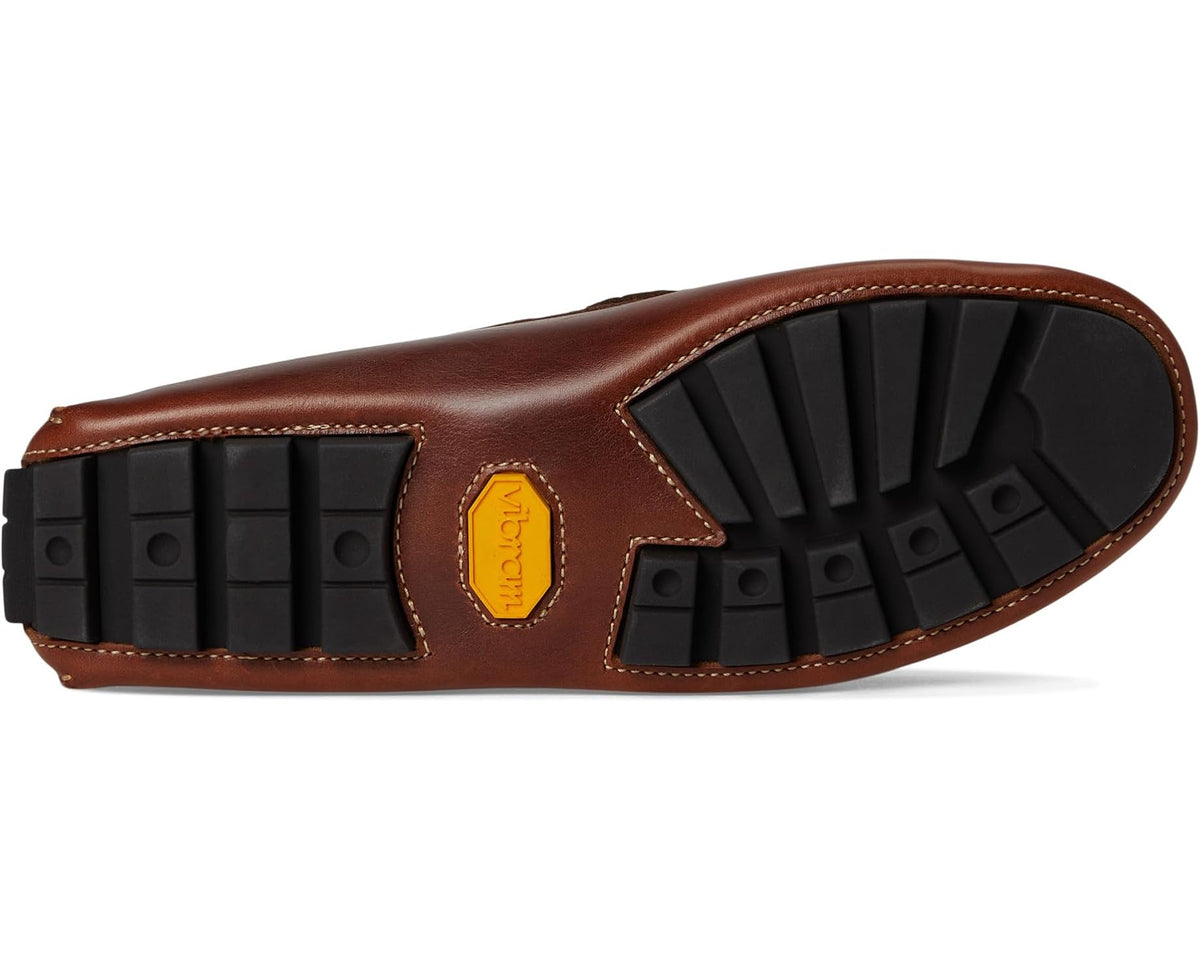 Cigar brown penny loafer outsole with textured rubber tread and branded tag