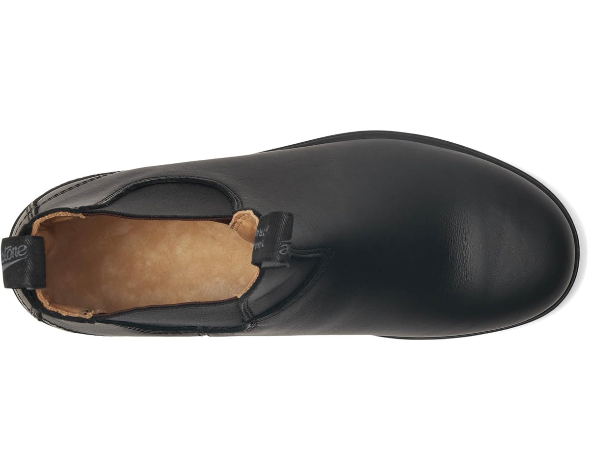 Black Chelsea boot with side gore and tan-lined interior, leather-look upper