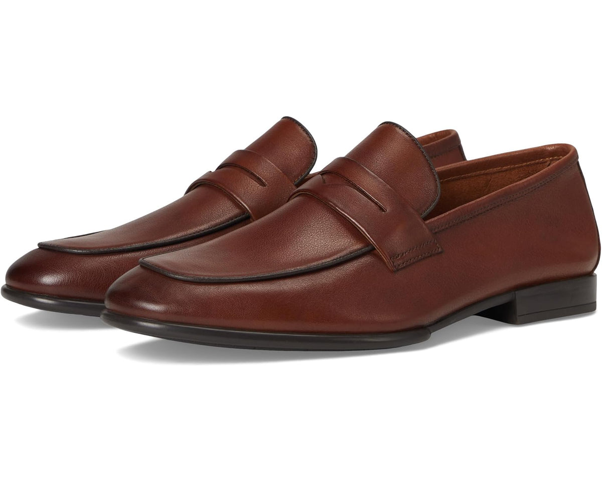 Men's leather loafer in dark tan/brown, slip-on design with apron and strap detail