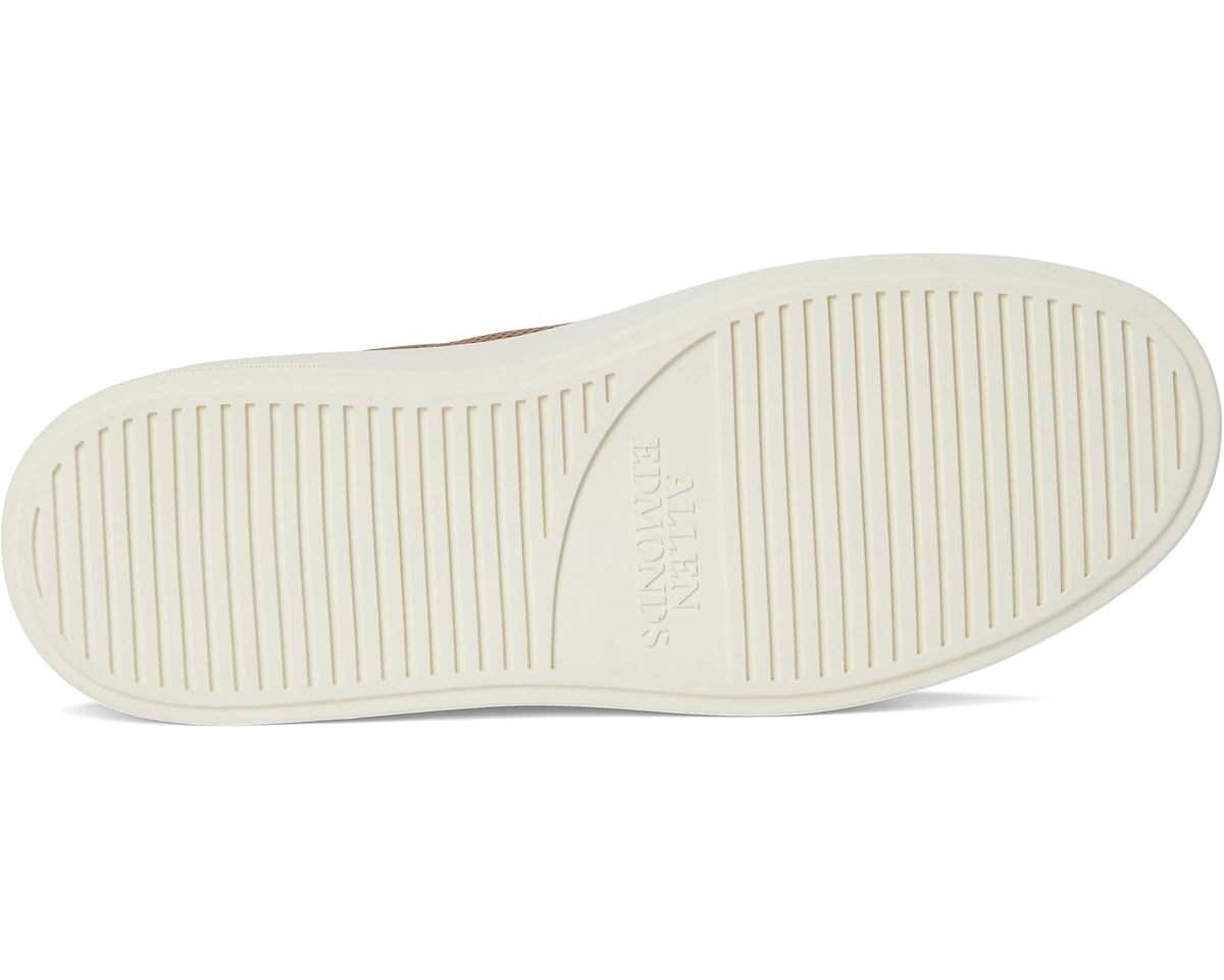 Tan leather sneaker outsole with ribbed rubber tread and Allen Edmonds logo