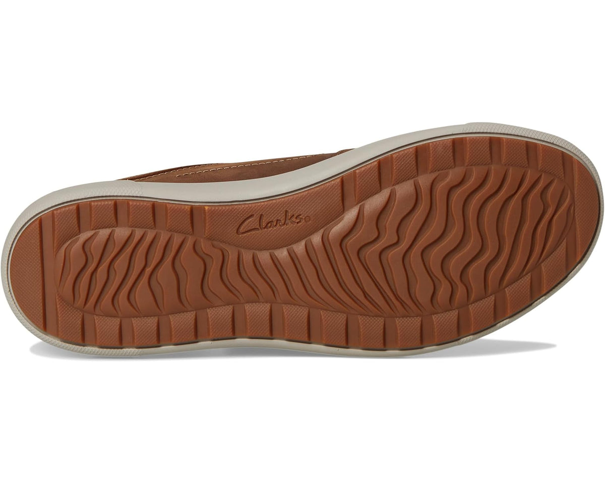 Brown sneaker outsole with textured tread and Clarks logo on the heel