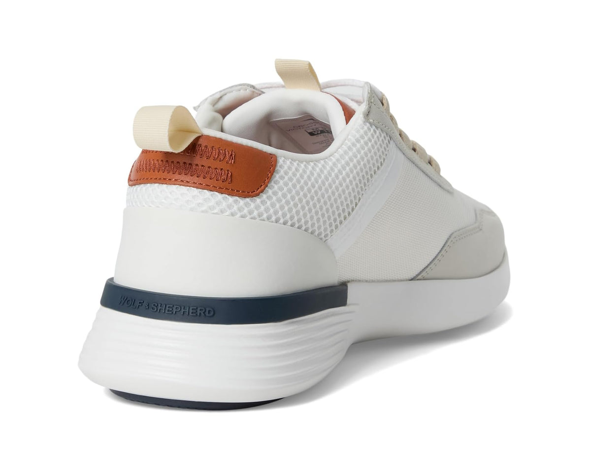 White sneaker heel view with cushioned collar, navy stripe, and tan leather patch