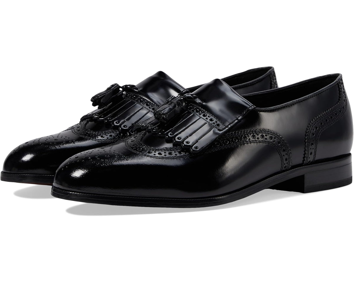 Black leather wingtip tassel slip-on dress shoe with brogue detailing