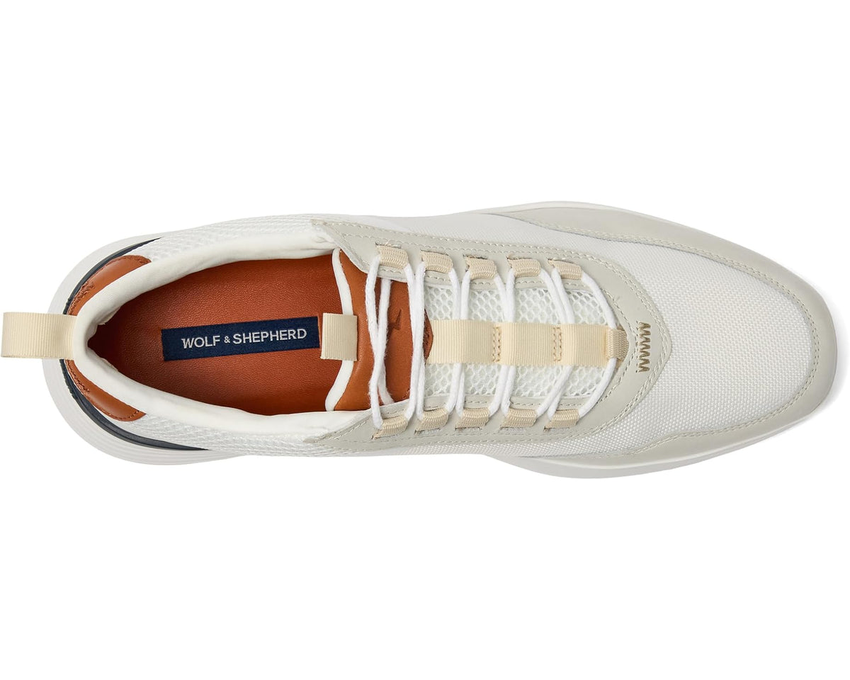 White low-top sneaker showing interior lining and lace-up front with brand label